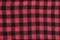 Checkered black and red textured fabric. Seamless. Close-up