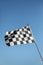 Checkered finish flag on light blue background