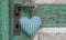 Checkered green heart shape hanging on door handle for wedding,