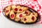 Checkered napkin, shortbread cookies with jam in brown dish on wooden table