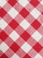 Checkered table cloth with red and white squares. Square pattern. Fabric texture.