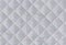 Checkered texture of white fabric with diagonal mesh embossing. Abstract material pattern or background. Close up shot