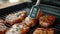 Checking for safe food temperature with digital instant thermometer. Kitchen meat thermometer against pork steaks on a grill