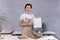 Checking sanitary standards in restaurant kitchens. Woman in kitchen holds documents in her hands