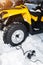 Checking tire pressure. Pumping air into auto wheel on the ATV 4wd quad bike stand in heavy snow.