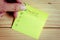 Checklist on colorful sticky note on wooden