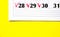 Checkmark on 28 29 30 numbers in the calendar on a yellow background. Mark on the calendar with a red marker. Calendar for plans,