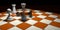 Checkmate the fallen black king with the queen, a pawn and a white tower on a brown and white chess board on a dark brown surface