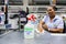 Checkout cashier staff wiping down surfaces at Pick `n Pay grocery store during virus outbreak