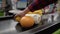 At the checkout counter in a supermarket, a woman lays out vegetables and fruits. 4k