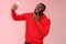 Cheeky cool african american confident bearded guy in red hoodie taking selfie update date app profile photo holding