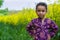 Cheeky Mixed Race African American Girl Child in Field of Yellow Flowers
