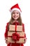 Cheered and happy christmas girl holding two gift boxes in the hands, wearing a santa hat isolated over a white