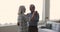 Cheerful active elderly husband and wife dancing and talking