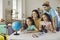 Cheerful and active family smiling and looking at the globe in preparation for a new vacation trip.