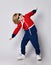 Cheerful active frolic blond kid boy in blue and red hoodie, pants and sunglasses is playing aircraft pilot