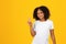 Cheerful adolescent african american girl in white t-shirt, show peace sign with hand