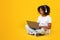 Cheerful adolescent african american girl in white t-shirt, wireless headphones with computer, watch online lesson