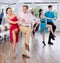 Cheerful adult couple practicing vigorous lindy hop in dance class