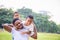 Cheerful african american father and two sons playing in park, Happiness family concepts, parent and childs play in park