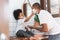 Cheerful African American Man and little boy having fun laughing with shaving foam on their faces in bathroom at home together