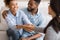 Cheerful african american spouses and psychologist handshaking in office