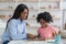 Cheerful african american woman speech therapist teaching little girl alphabet