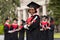 Cheerful african american young lady in graduation costume