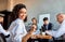 Cheerful African Businesswoman Sitting With Business Partners In Modern Office