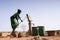 Cheerful African ethnic Girl Bringing Crisp Water in a village