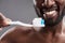 Cheerful afro American man getting ready to brush teeth