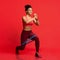 Cheerful afro fitness girl making working out with resistance band