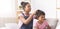 Cheerful afro girl making hairdo to her baby sister