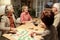 Cheerful aged woman laughing while playing name game with friends