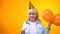 Cheerful aging woman with balloons celebrating birthday, positive attitude