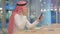 Cheerful Arab Businessman Talking on Smartphone