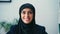 cheerful arabian businesswoman in hijab looking