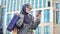 Cheerful Arabic female chatting on phone after shopping, standing outdoors mall