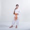 Cheerful athlete in karategi and with an orange belt