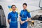 Cheerful attractive slim stewardesses standing at the plane entrance