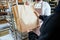 Cheerful baker delivering bread to client in store