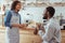 Cheerful baristas socializing during coffee break