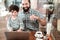 Cheerful beaming father and son having fun on weekend in cafeteria