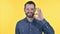 Cheerful Beard Young Man doing OK Sign, Yellow Background