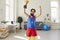 Cheerful bearded brutal man athlete in multicolored sport clothes standing holding golden first prize trophy