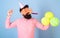 Cheerful bearded man in birthday cap blowing party whistle, fun time, happiness concept. Artist in big crazy glasses