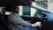 Cheerful bearded young man sitting in car and listens listening to favorite songs.