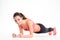 Cheerful beautiful fitness woman doing plank exercise