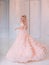 Cheerful beautiful princess girl blonde laugh smiling. Luxury ballroom evening elegant trendy tulle pink dress