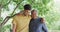 Cheerful biracial father and son standing with arms around shoulders smiling to camera